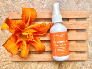 anti-aging serum bottle with orange daylily